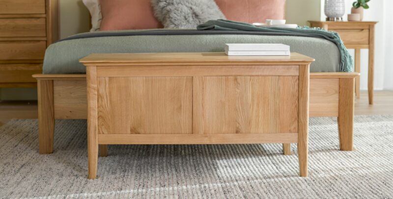 Natural oak Copenhagen blanket box in a pink and green bedroom.