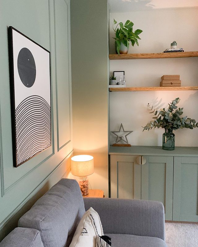 Oak Furnitureland grey Evie sofa in a living room with green walls and monochrome accent details.