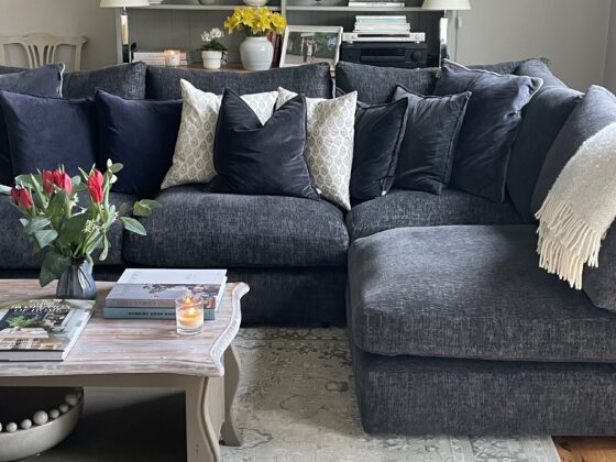 Oak Furnitureland Malvern charcoal corner sofa in a traditional living room with built in shelving styled with glassware.