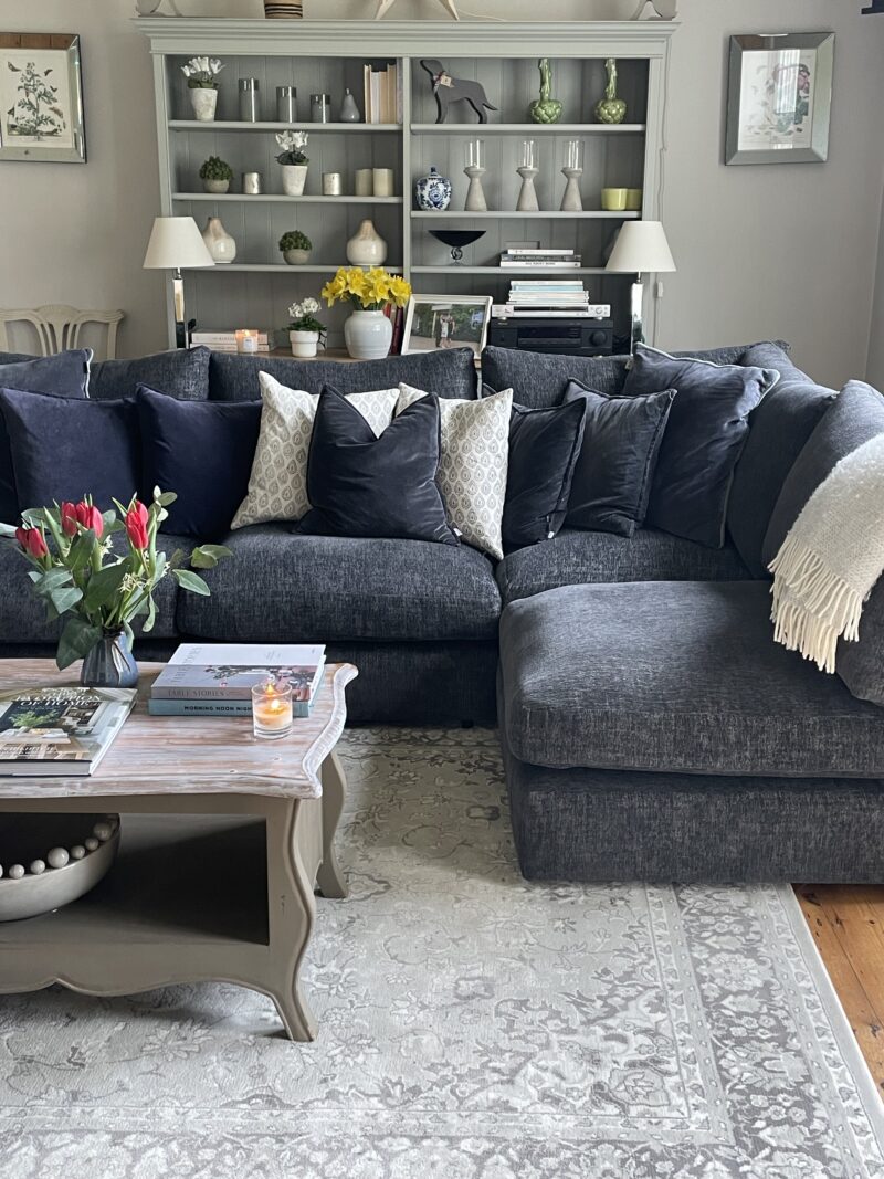 Oak Furnitureland Malvern charcoal corner sofa in a traditional living room with built in shelving styled with glassware.