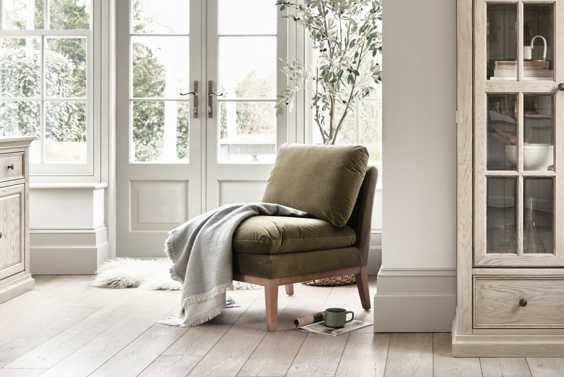 Oak Furnitureland green velvet Cosmo accent chair styled with Burleigh cabinetry range.