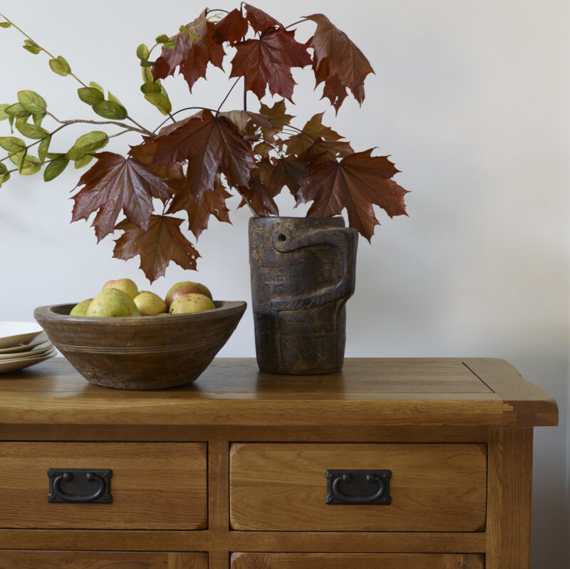 Original Rustic sideboard topped with decorative accessories.