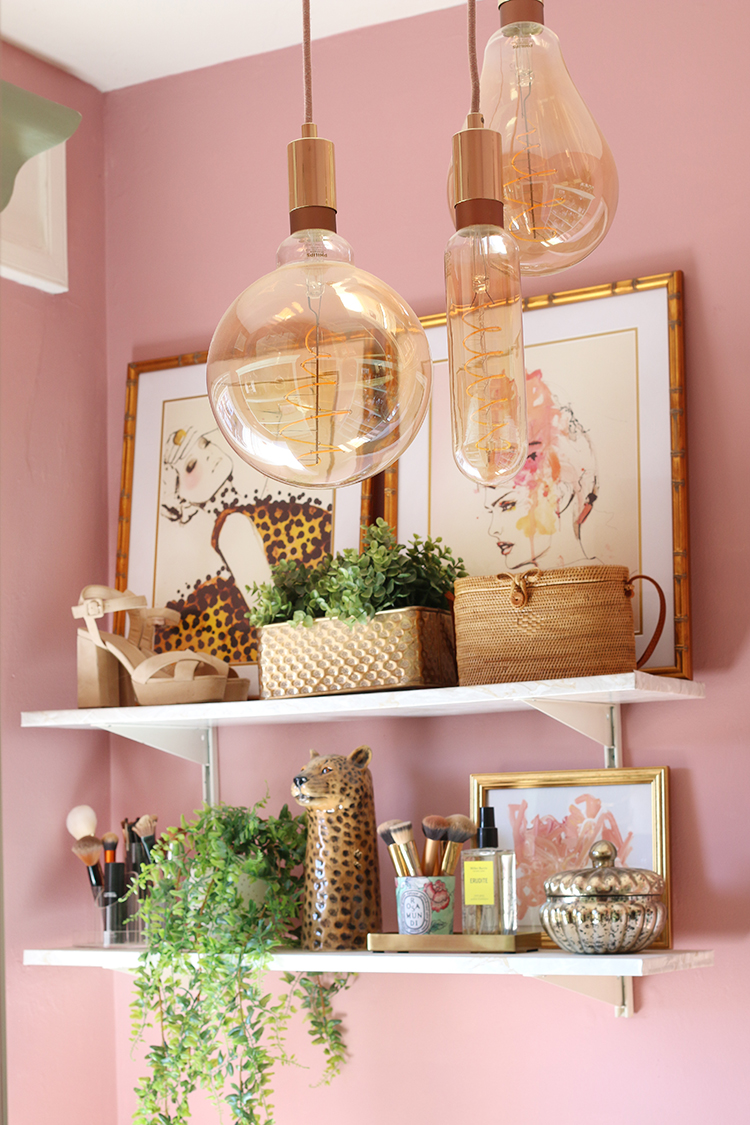 White wall shelving, pink walls and ornate light bulbs