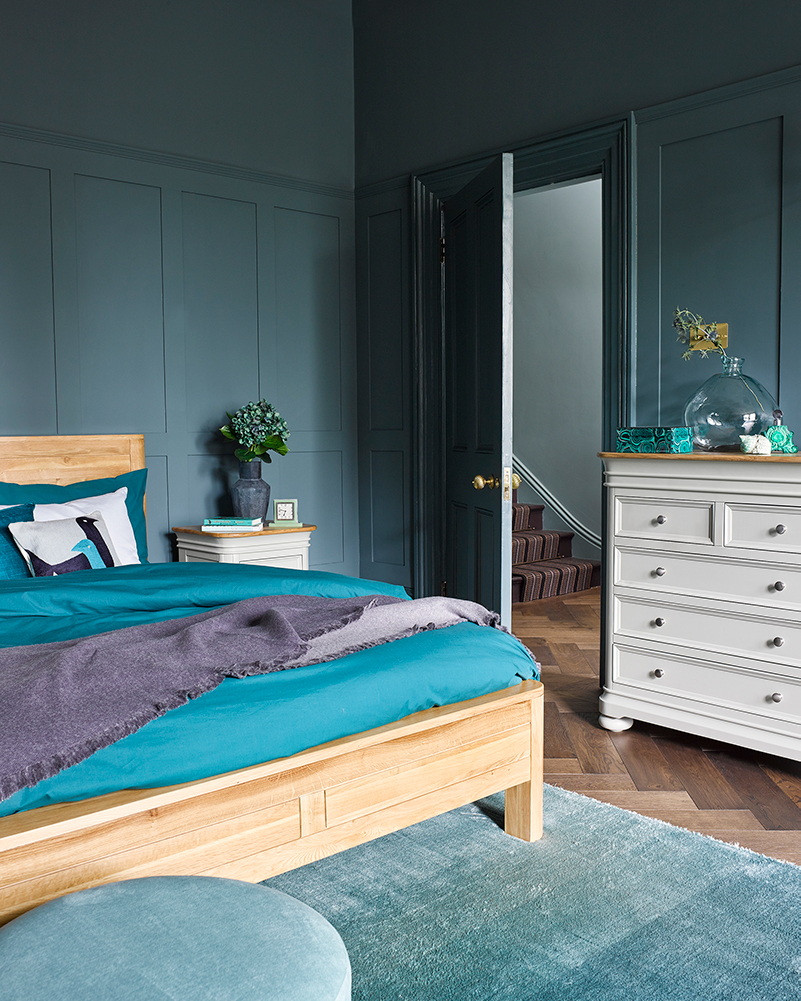blue green toned bedroom with oak double bed