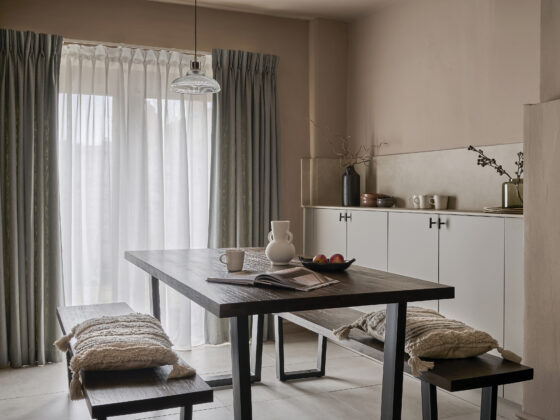 Dark stained industrial-style Detroit dining table with matching benches in a neutral-palette kitchen/diner.