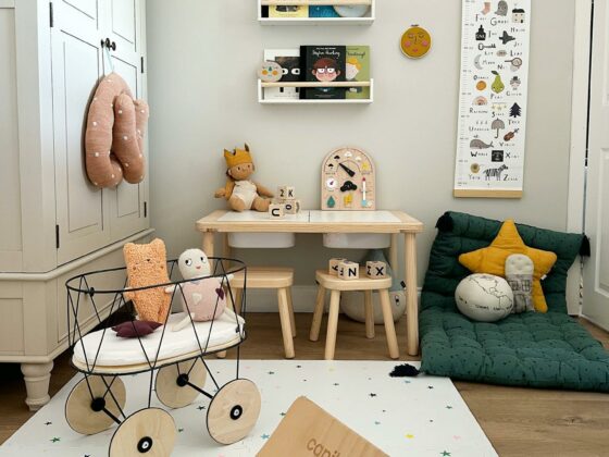 Playful children's bedroom with a pale wardrobe and colourful decorative touches.