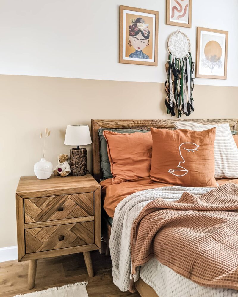 Parquet bed and bedside table with terracotta bedding and waffles throws.