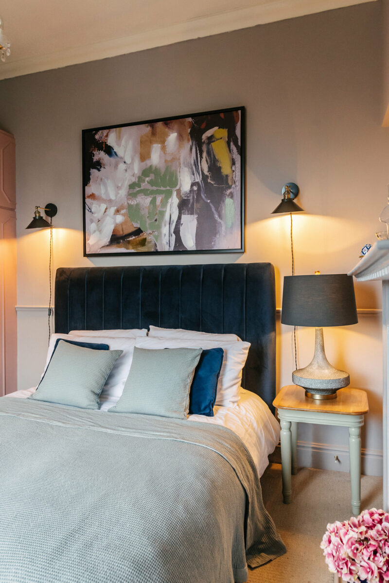 Navy blue bed styled in light blue bedding.