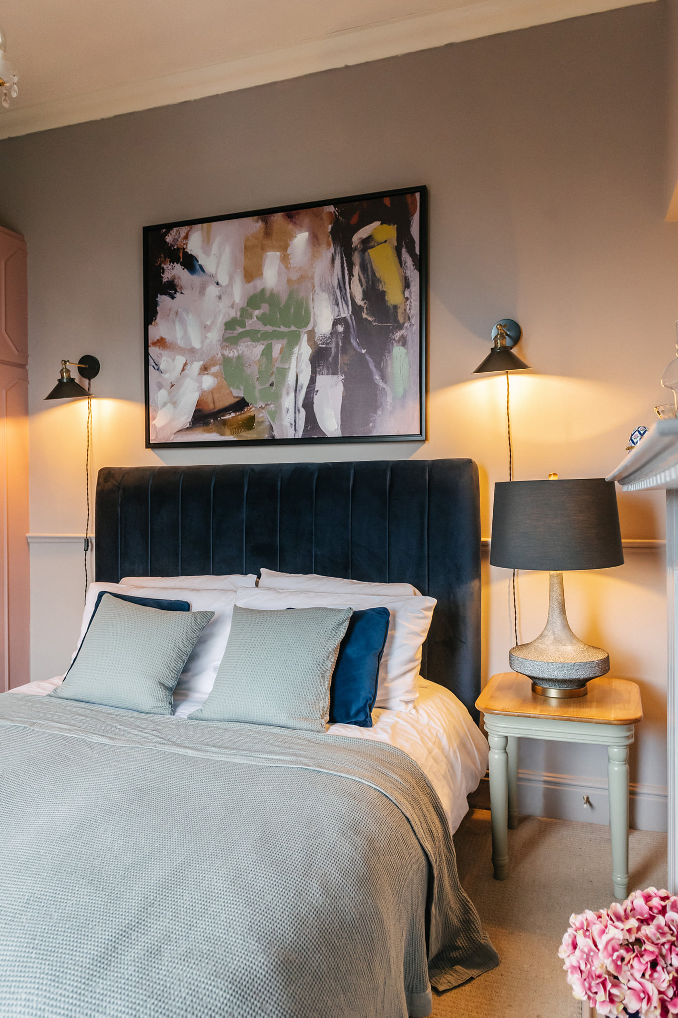 Navy blue bed styled in light blue bedding