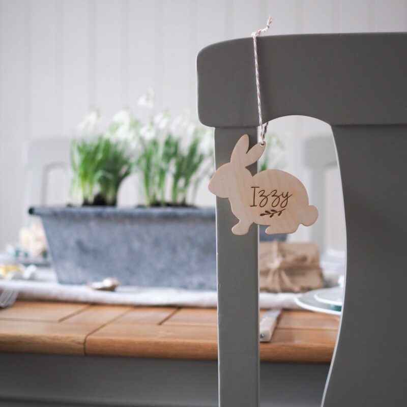 Oak Furnitureland grey painted and oak dining table with bunny Easter decoration and spring flowers.