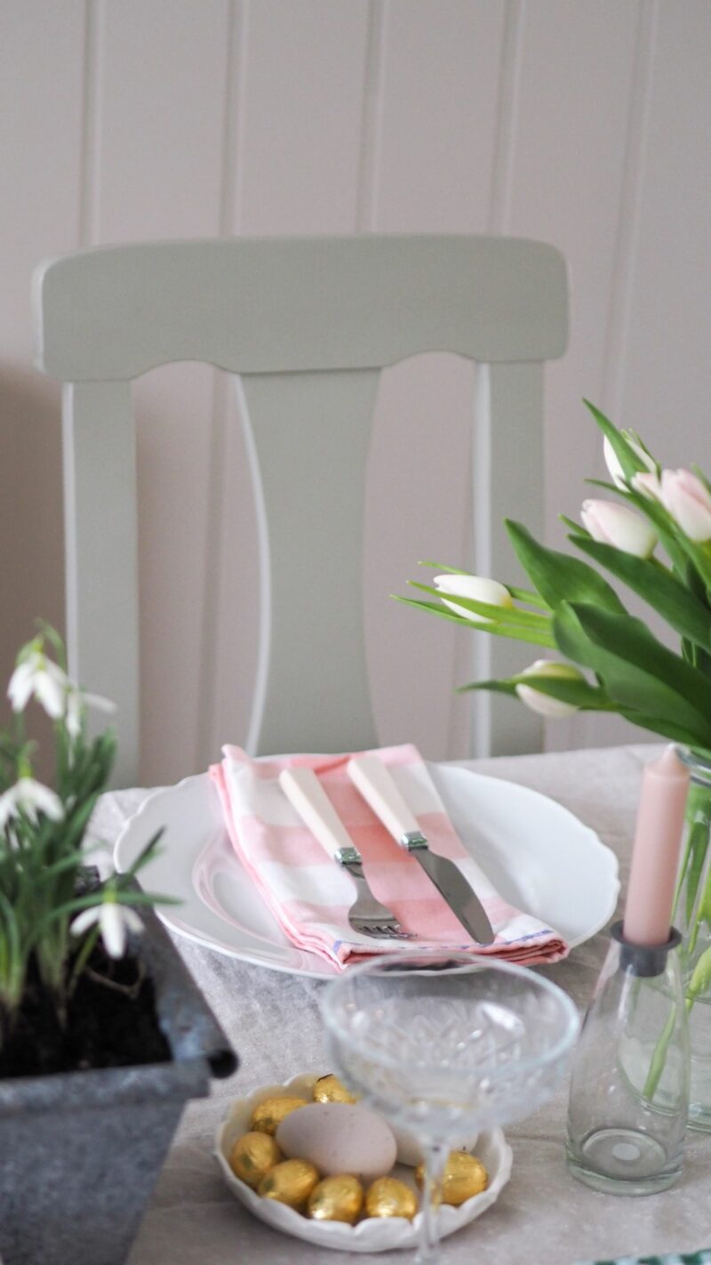 Oak Furnitureland grey painted dining chair & table with pastel napkins, tulips & gold Easter eggs.