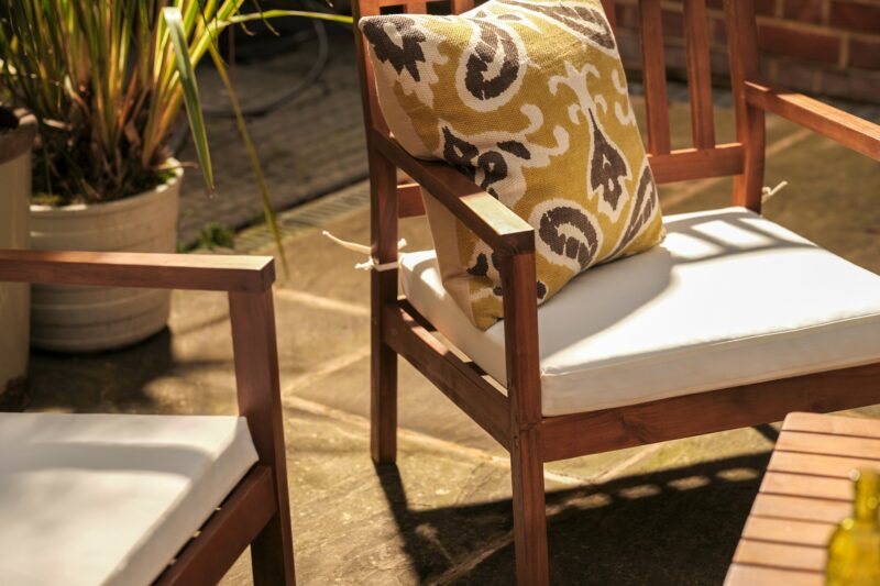 Oak Furnitureland Java lounge set chairs with cream seat cushions and patterned accent cushion.