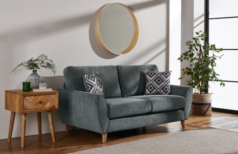 Milner grey retro-style sofa with beech legs and patterned scatter cushions. 