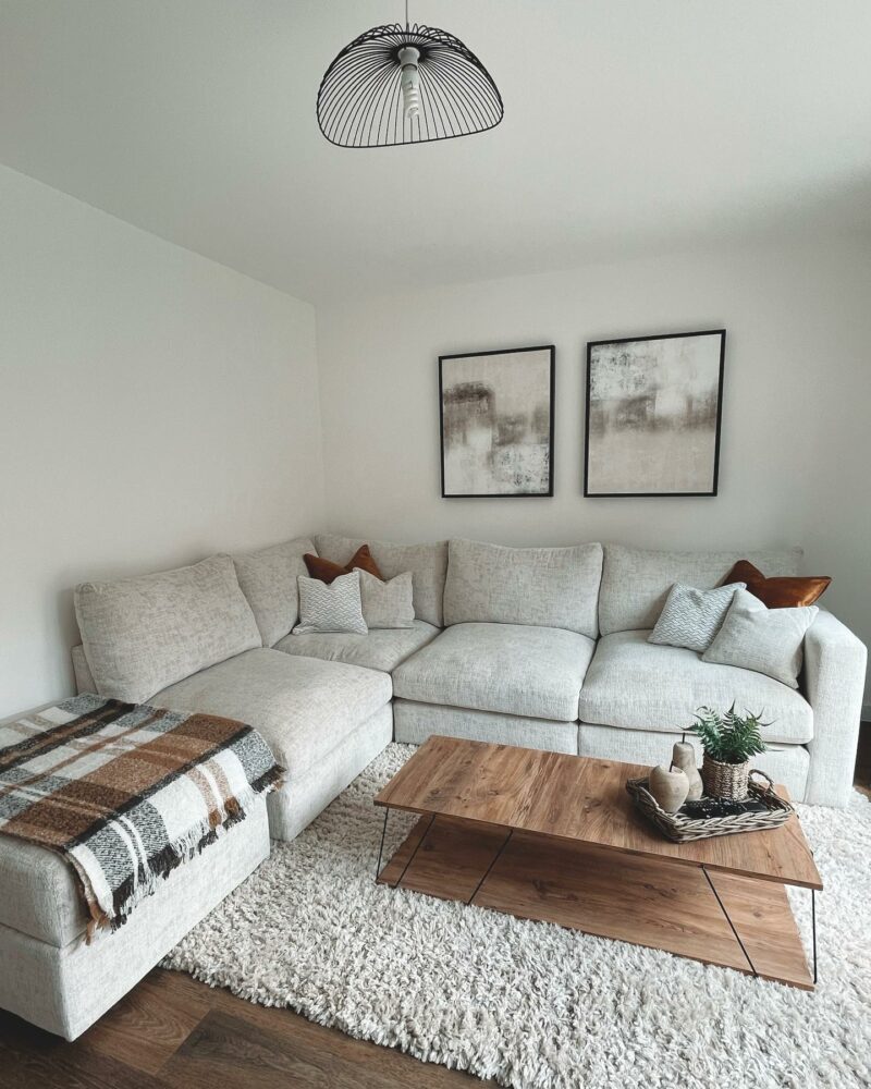 Oak Furnitureland grey Malvern corner sofa in a neutral living room with a cream rug and wooden coffee table.
