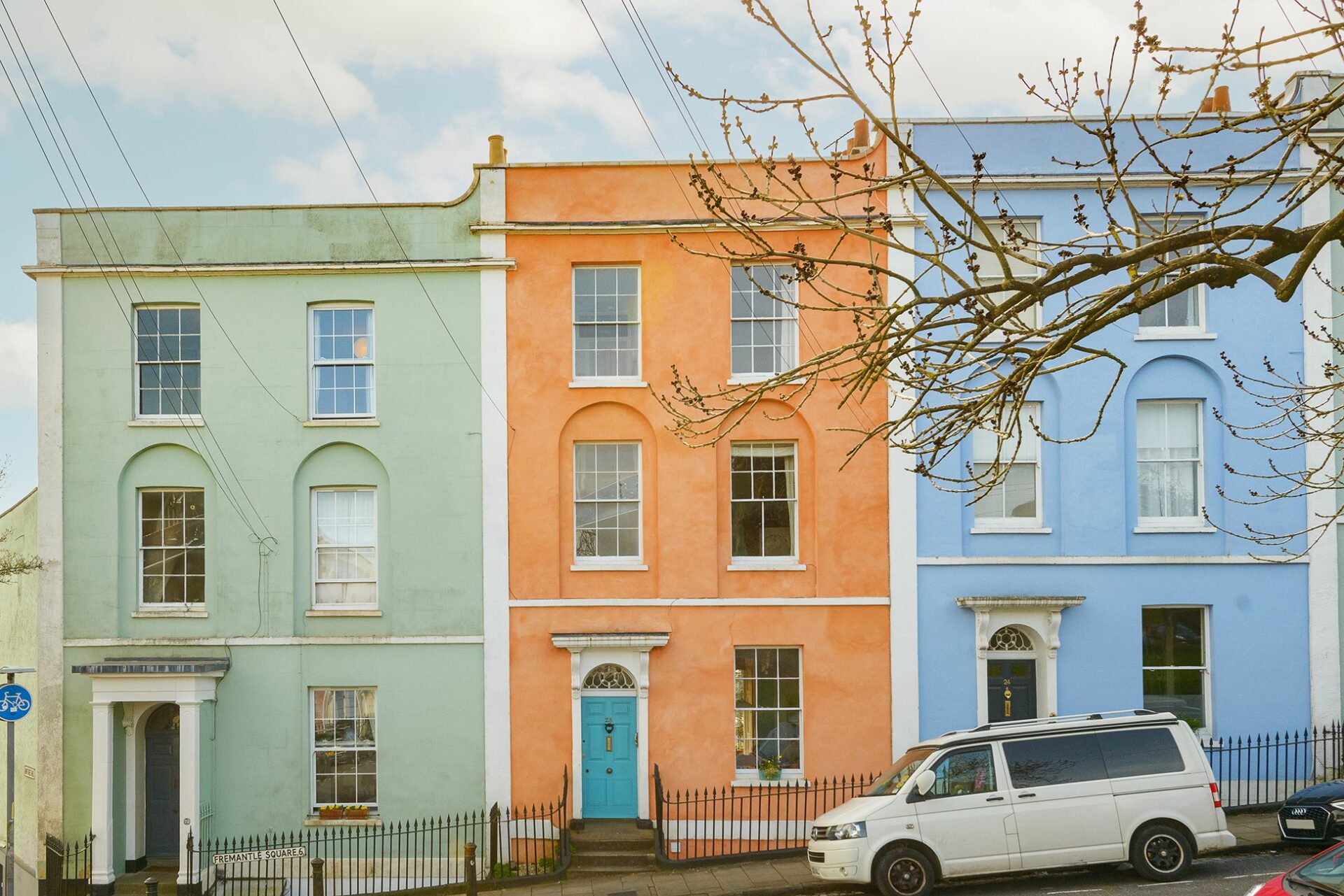 House fronts-outdoors-colourful terrace houses-white camper van-street view