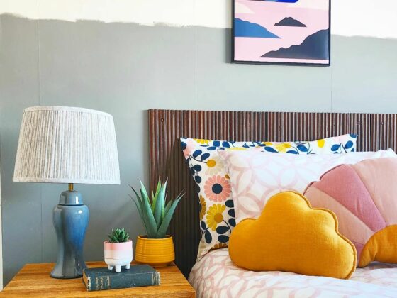 A bed and bedside table-bedroom furniture-wooden side table with drawers-patterned bedding-wall art