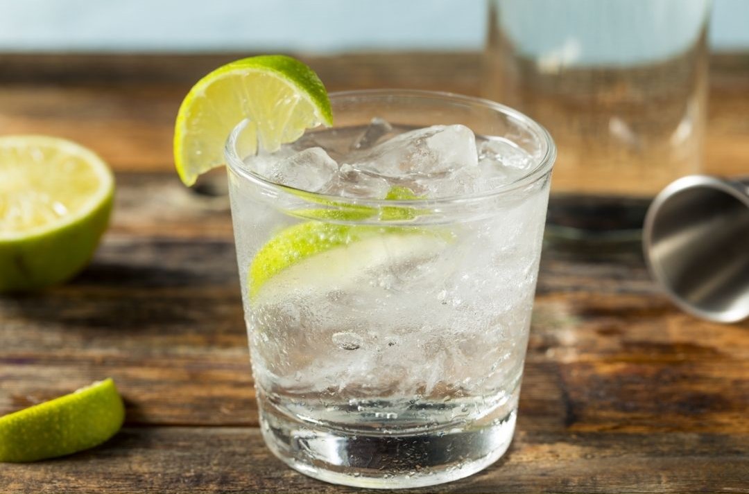 A glass-kitchen-gin and tonic-cocktail making-chopping board