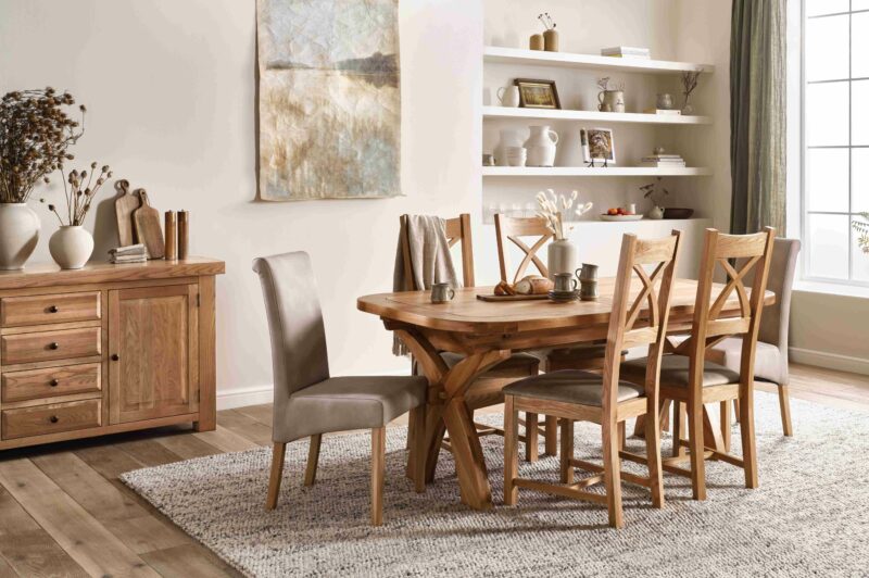 A dining table, dining chairs and sideboard-dining room furniture-oak dining table and dining chairs-upholstered dining chairs-large wooden sideboard-neutral walls with shelving