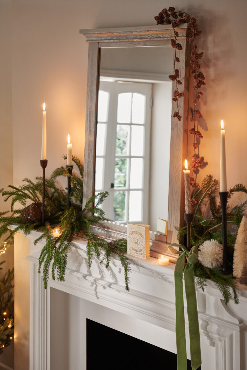 A mirror and fireplace-dining room furniture-neutral walls--scandinavian design-wooden grey mirror-Christmas fireplace-Christmas tree