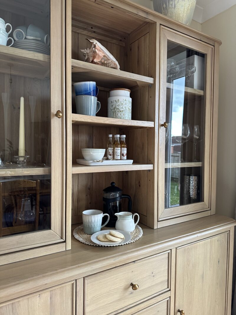 A dresser-dining room furniture-coffee station-natural oak large dresser-display cabinet-glass doors-crockery-cafetiere-cream walls