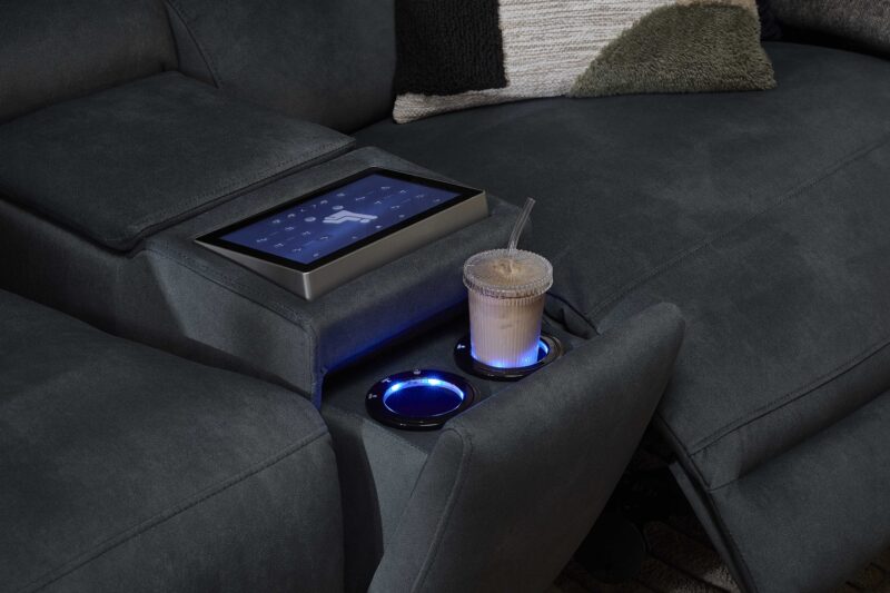 A sofa-living room furniture-dark blue recliner sofa with console screen and cup holders-tactile cushion-armrest-iced drink in glass cup with straw