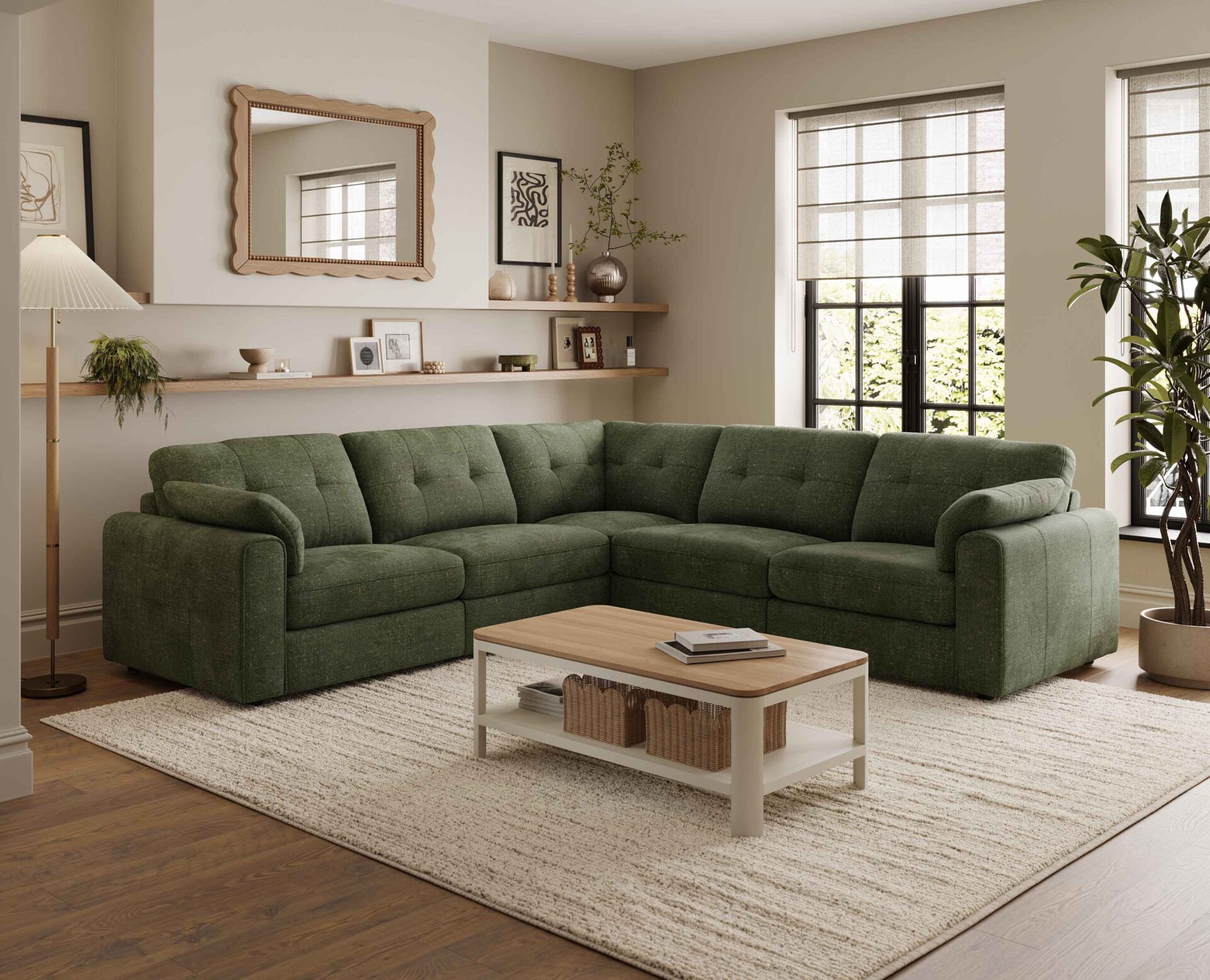 A corner sofa, coffee table, and nest of tables-living room furniture-dark green corner modular sofa-wooden and cream painted coffee table with shelf-wooden and cream painted nest of tables-cream textured rug-dark wooden floor-scallop edged mirror-built in wooden sheving-floor standing lamp-framed wall art-potted house plant-crittall windows-sheer blind